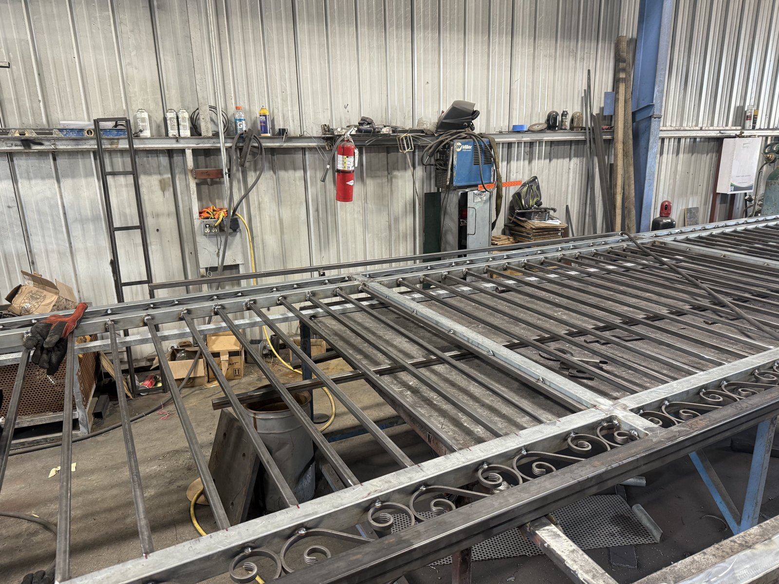 Ornamental steel gate panels with scroll details being fabricated in the Ryze metal shop
