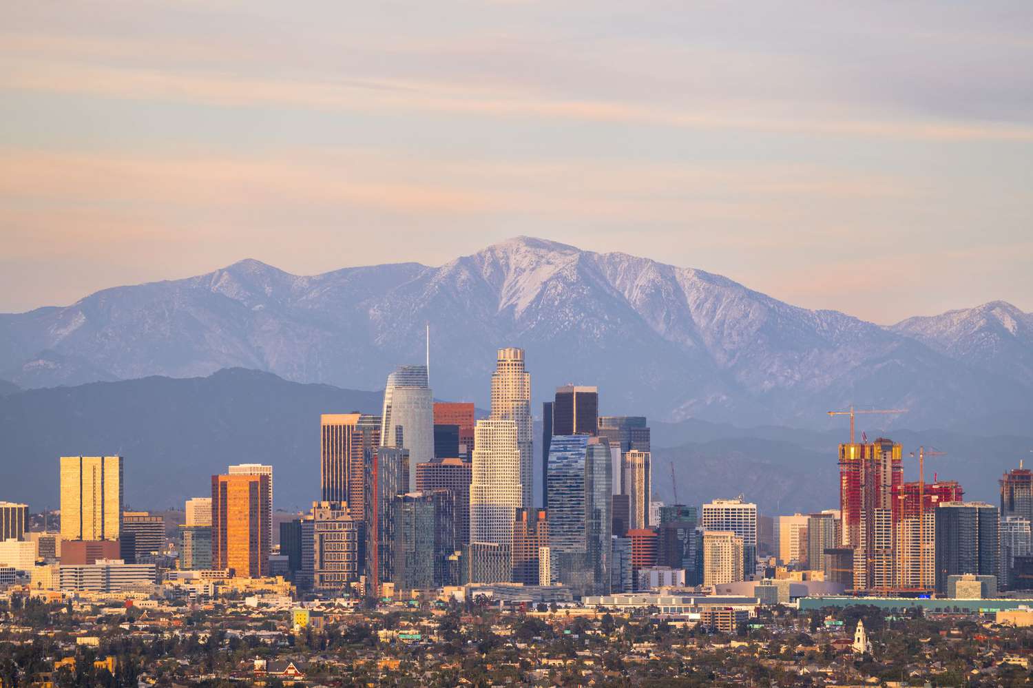 Los Angeles skyline with snow-capped mountains representing Ryze Fence Systems coverage across Southern California