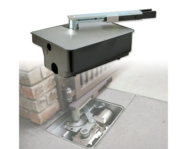 In-ground swing gate operator with its above-grade housing and articulated arm, shown over a cutaway of the buried housing at a driveway gate