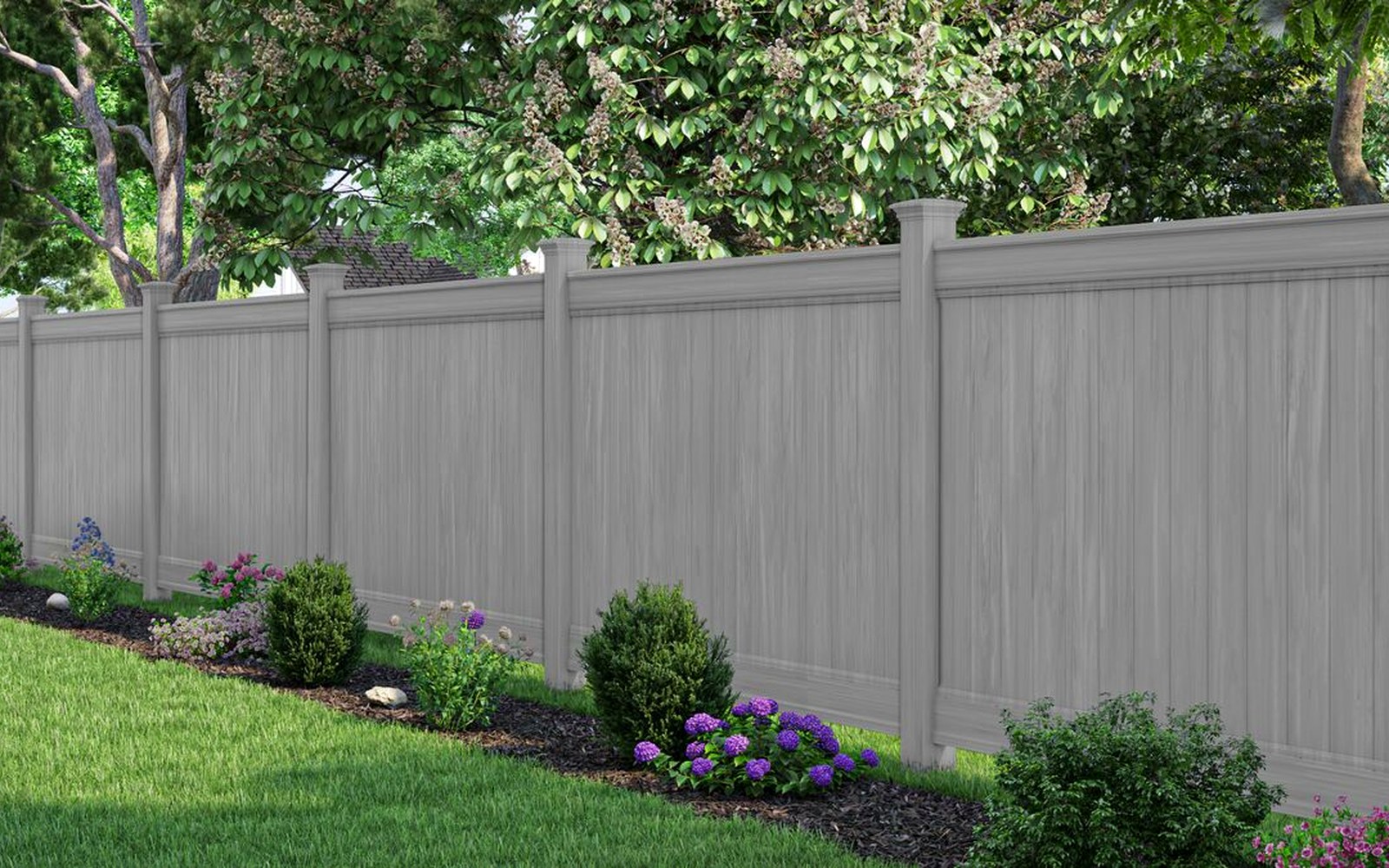 White vinyl privacy fence around a residential backyard