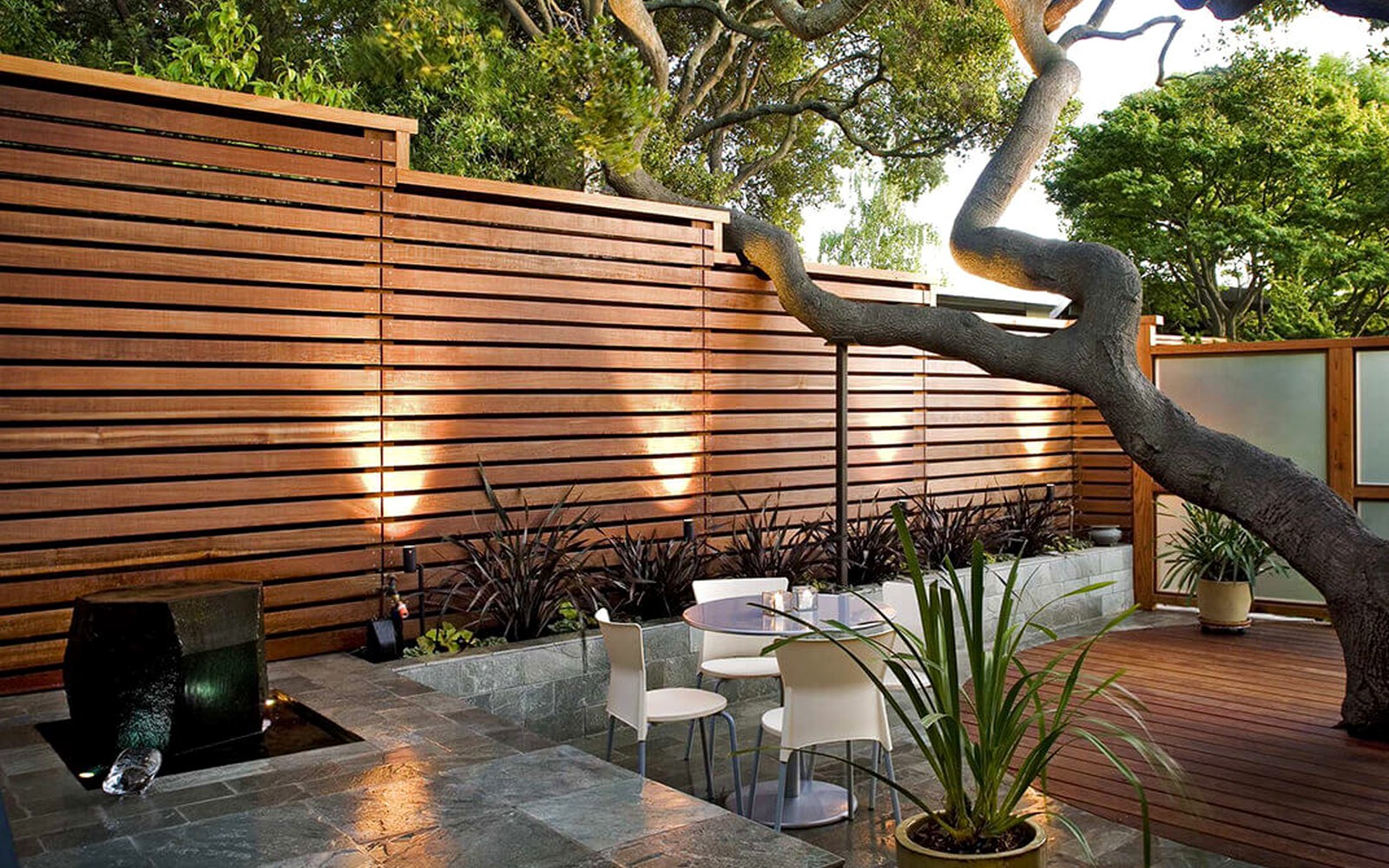 Horizontal cedar slat privacy fence beside a modern home
