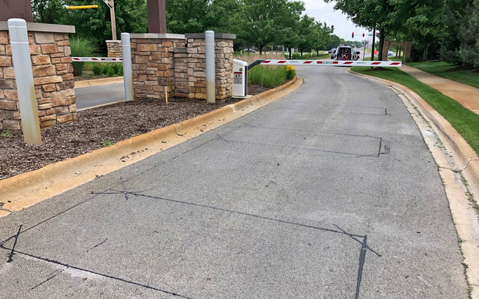 Controlled vehicle lane at a parking structure entrance where detection loops are used