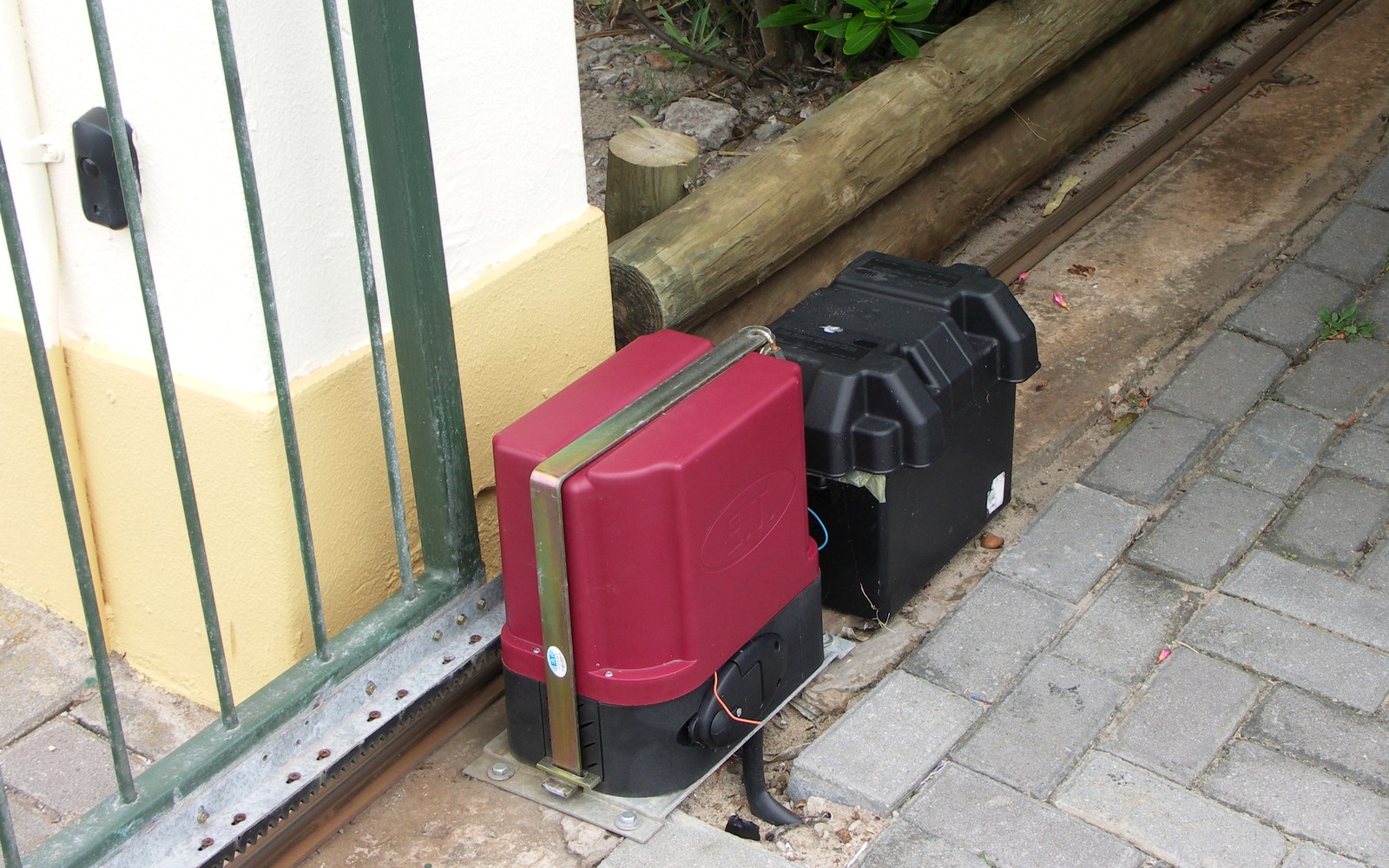 Heavy steel slide gate on a track at a commercial driveway entrance